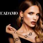 Girl with long and shiny wavy hair. Beautiful model with curly hairstyle .